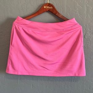 PGA ladies, pink golf skirt.